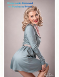 Woman in a light blue dress posing against a plain background with nude version 2 included